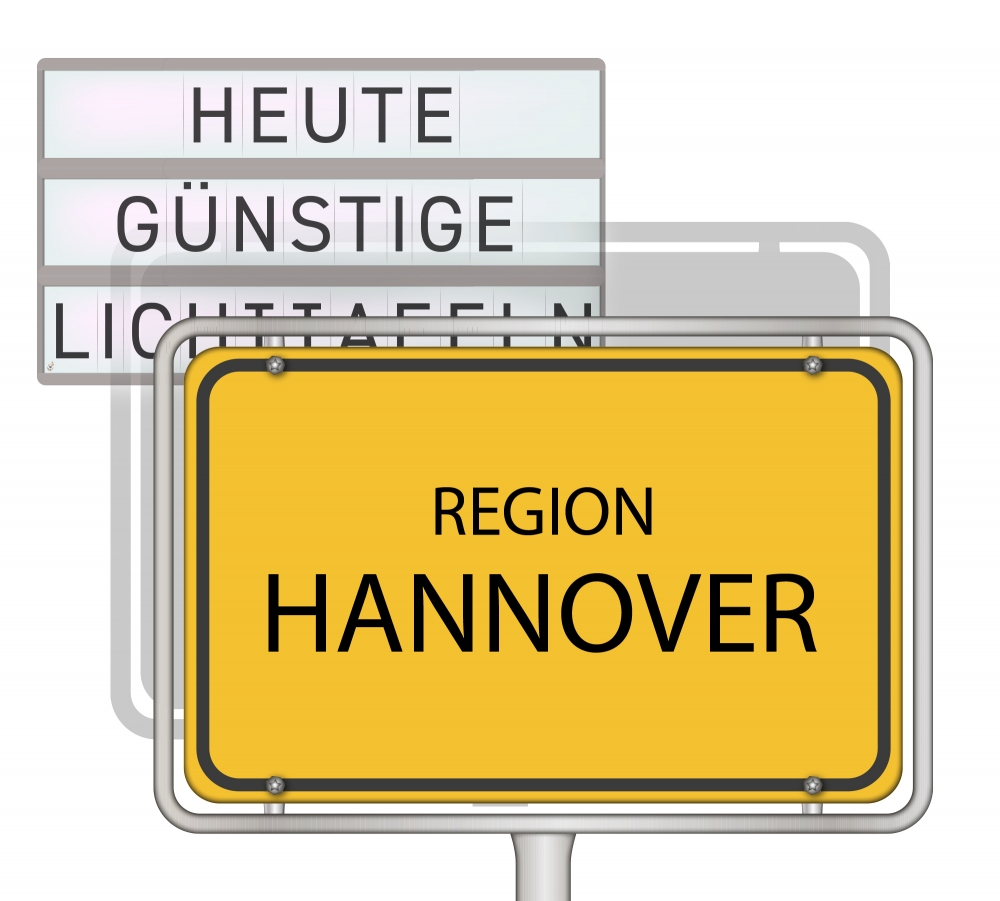 Zu sehen ist eine Lichttafel mit dem Ortschild Hannover im Vordergrund.